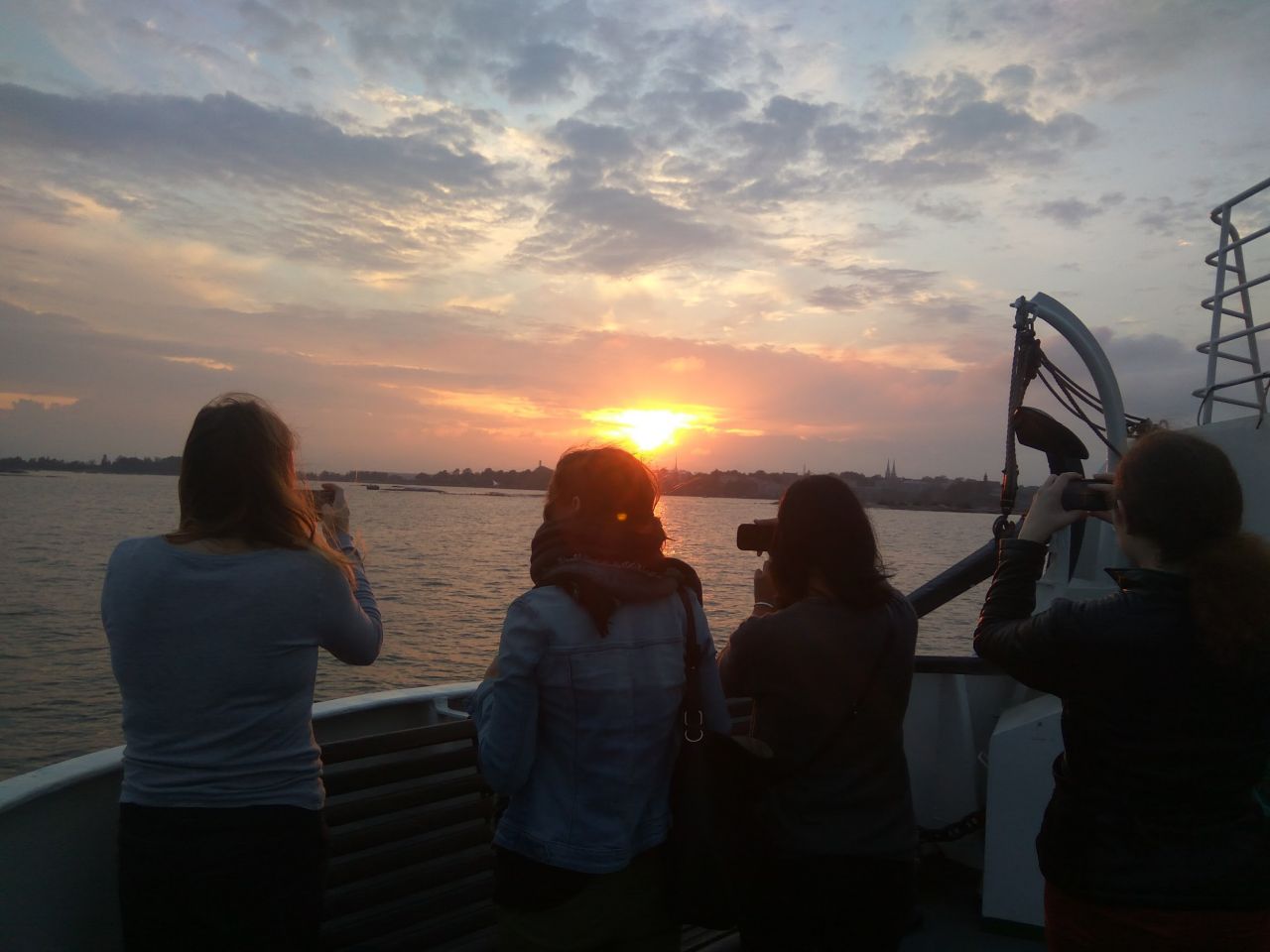 Julia, Rita, Milena and Maike watching the sunset on the way to Suomenlinna